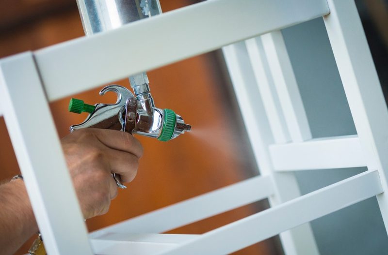 Lacado en blanco de una silla de madera con pistola